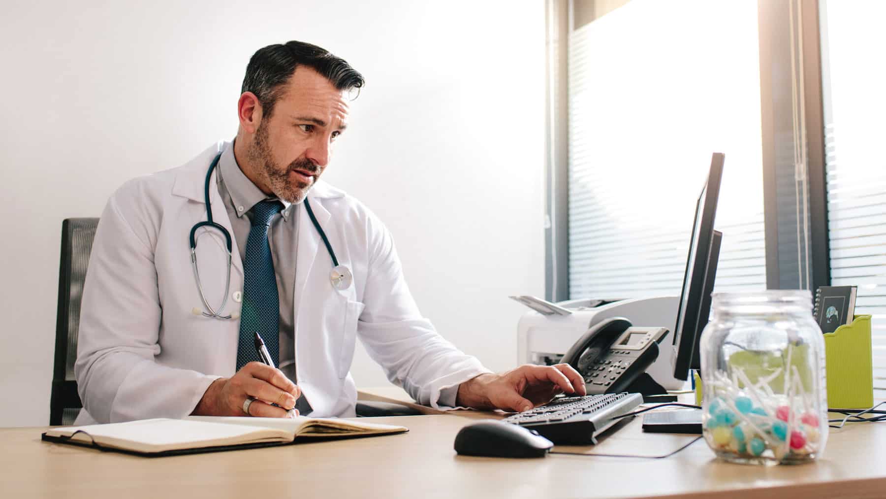 Doctor working on his computer